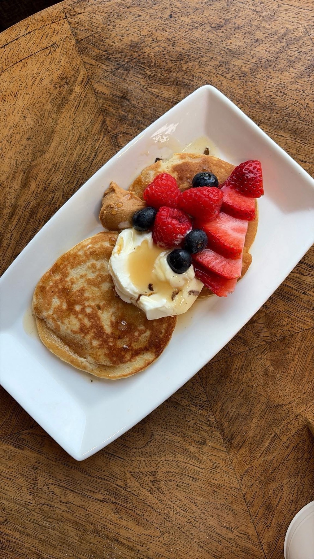 Pancakes with berries, cream and honey